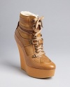 Take the ultimate approach to the athletic-inspired wedge bootie in this simply smashing Burberry design.