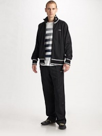 The sporty track jacket leaves the field and enters the everyday with this design, sharpened with contrast tipping and vertical stitching allover. Zip front Logo embroidery Side zip pockets 62% polyester/38% cotton Machine wash Imported The sporty track jacket leaves the field and enters the everyday with this design, sharpened with contrast tipping and vertical stitching allover. Zip front Logo embroidery Side zip pockets 62% polyester/38% cotton Machine wash Imported