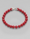 Smooth, polished coral beads are laced on a sterling silver chain. From the Spiritual Bead Collection Sterling silver Coral 8mm beads About 8½ long Lobster clasp Imported 
