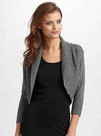 Wide shawl collar knit in ultra soft silk/cashmere. Ribbed collar, cuffs and hem Cropped sleeves About 16 from shoulder to hem 85% silk/15% cashmere; dry clean Imported Wide shawl collar knit in ultra soft silk/cashmere. Ribbed collar, cuffs and hem Cropped sleeves About 16 from shoulder to hem 85% silk/15% cashmere; dry clean Imported