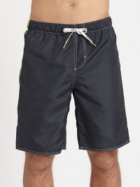 Classic swim trunk style, in quick-drying nylon, finished with a back patch pocket and vibrant contrast tipping.Elastic drawstring-tie waistBack patch pocketInseam, about 9PolyesterMachine washImported Classic swim trunk style, in quick-drying nylon, finished with a back patch pocket and vibrant contrast tipping.Elastic drawstring-tie waistBack patch pocketInseam, about 9PolyesterMachine washImported