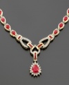 Blazing with the grand splendor of a stunning 12 ct. t.w. of rubies and 1 1/6 ct. t.w. of diamonds, this striking 14K gold toggle-style necklace will make any event a gala occasion. Prized for centuries as a symbol for royalty, the regal ruby is the birthstone for July.