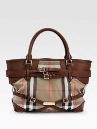 Iconic Burberry check makes a statement in this roomy leather-trimmed carryall, finished with goldtone hardware and buckled leather straps.Double top handles, 5 drop Protective metal feet Two inside zip pockets Cotton lining 14W X 11H X 6D Imported Iconic Burberry check makes a statement in this roomy leather-trimmed carryall, finished with goldtone hardware and buckled leather straps.Double top handles, 5 drop Protective metal feet Two inside zip pockets Cotton lining 14W X 11H X 6D Imported