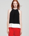 A neutral touch of bold color blocked flair enriches this wispy silk Theory top.