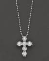 Diamond cross pendant in white gold formed from a gleaming cluster of orbs, with ball chain.