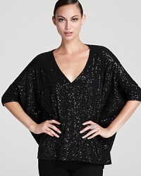Dripping with decadence, a statement DKNY top illuminates your look as allover sparkle stuns against an oversized silhouette. Dripping with decadence, a statement DKNY top illuminates your look as allover sparkle stuns against an oversized silhouette.