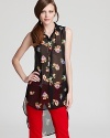 Dress to the extreme in this sheer Aqua blouse with exaggerated high/low hem and vibrant floral print. Team the blooming look with bold denim for a colorful combo.