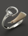 A horn accent adds edge to Gucci's signature horsebit design in this sterling silver statement bangle.