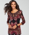 Delicate beading adds even more sparkle to the intricate, exotic print decorating INC's mesh tunic top.