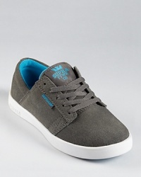 With vivid blue trim and lining and a soft suede upper, this unique low top design rests upon a lightweight cup sole for sporty comfort and style. With vivid blue trim and lining and a soft suede upper, this unique low top design rests upon a lightweight cup sole for sporty comfort and style.
