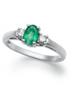 Enviable green hues. This vibrant 14k white gold ring features an oval-cut emerald (3/8 ct. t.w.) and round-cut diamond side stones (1/8 ct. t.w.).