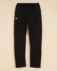A more structured and modern vision of the classic sweatpant, the sporty Ferrari pant from PUMA features pieced contoured panels with sateen trim rendered in a cool tonal palette. A more structured and modern vision of the classic sweatpant, the sporty Ferrari pant from PUMA features pieced contoured panels with sateen trim rendered in a cool tonal palette.