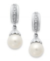 A class act. These elegant earrings feature cultured freshwater pearls (7-7-1/2 mm) with sparkling diamond accents for extra shine. Set in sterling silver. Approximate length: 7/8 inch. Approximate width: 1/4 inch.