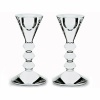 Fresh sculpted design comprising sharp edges and smooth planes. Their beauty is striking enough to stand alone, yet richly enhanced with the warm glow of candles. 5 3/8H vega candlestick, pair. Also available: 10 5/8H vega candlestick, each.