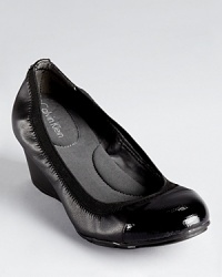 Trimmed in elastic for flexible comfort, Calvin Klein's Prizma wedges boast a walkable 2 heel. Trimmed in elastic for flexible comfort, Calvin Klein's Prizma wedges boast a walkable 2 heel.