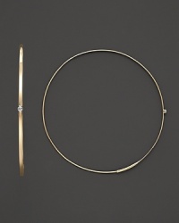 A graceful hoop in yellow gold with diamond accent and invisible closure to create a perfectly elegant orb to complement your most refined ensembles. Designed by Lana. A graceful hoop in yellow gold with diamond accent and invisible closure to create a perfectly elegant orb to complement your most refined ensembles. Designed by Lana.