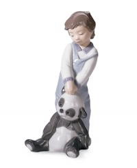 Totally inseparable, the cute little boy and his cherished panda bear from Lladro's First Discoveries figurine evoke the sweet innocence of youth in glazed porcelain.