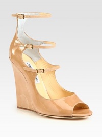 Shiny patent leather forms this lifted silhouette, with three adjustable straps and an open toe. Self-covered wedge, 4½ (115mm)Patent leather upperThree adjustable strapsLeather lining and solePadded insoleMade in Italy Shiny patent leather forms this lifted silhouette, with three adjustable straps and an open toe. Self-covered wedge, 4½ (115mm)Patent leather upperThree adjustable strapsLeather lining and solePadded insoleMade in Italy
