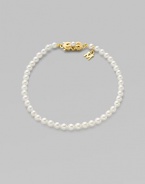 A strand of white cultured pearls with signature clasp closure.4mm white cultured pearls 18K yellow gold Length, about 7 Minuette clasp closure Imported 