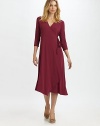 Universally flattering, this wrap dress offers a slightly-relaxed fit.V-neckThree-quarter sleevesWrap-front designAsymmetrical hemAbout 47 from shoulder to hem92% rayon/8% Lycra®Machine washMade in USA of imported fabric