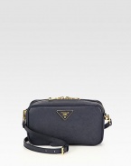 Crossbody design in saffiano leather with a front goldtone logo.Detachable adjustable shoulder strap, 21½-23½ dropTop zip closureOne inside zip pocketOne inside open pocketSignature jacquard lining8¾W X 4¾H X 2½DMade in Italy