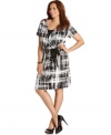 Get chic career style with Elementz' short sleeve plus size dress, defined by a faux wrap design.