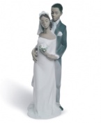 Bride and groom stand close in a loving embrace in this beautifully crafted figurine/cake topper from Lladró. Stands 8 tall.