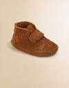 Classic moccasin stitching, fringe and an easy on/easy off grip-tape strap make this plush suede pair a must-have for baby.Grip-tape strap closureSuede upperSuede solePadded insoleImported