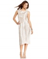 Jones New York's dress features a flattering faux-wrap silhouette and unstoppable metallic shimmer!