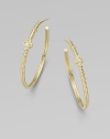 From the Jolie Collection. Elegantly fluted gold hoops, accented with gold beading and quatrefoil shapes set with sparkling diamonds.Diamonds, .12 tcw14k yellow goldDiameter, about 1½Post backImported