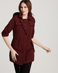 A decadent shade of plum outfits the classic Burberry Brit trench for a bold take on a sleek silhouette. A decadent shade of plum outfits the classic Burberry Brit trench for a bold take on a sleek silhouette.