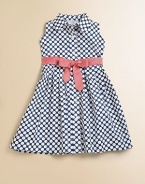 Bold polka dots create a fresh, modern look in a simple shirtdress with a wide grosgrain ribbon bow.Point collarSleevelessButtons from neck to hemContrast grosgrain ribbon bow beltFlared skirtCottonMachine washImported Please note: Number of buttons may vary depending on size ordered. 