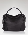 A sleek, chic leather hobo with contemporary panel details and a clever lockable top zip. By Salvatore Ferragamo.