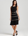 A swing skirt lends a ladylike look to this belted Anne Klein dress, trimmed in metallic stripes.