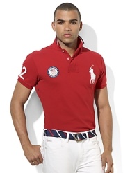 The prestige, tradition and athletic greatness exemplified by the Olympic Games are brought to life in this custom-fit polo adorned with sporty numerals, city text and a flag at the back celebrating Team USA's participation in the 2012 Games. The prestige, tradition and athletic greatness exemplified by the Olympic Games are brought to life in this custom-fit polo adorned with sporty numerals, city text and a flag at the back celebrating Team USA's participation in the 2012 Games.