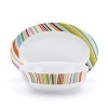Give your table a lively lift with this colorful Echo Design completer set, featuring a luxe porcelain serving bowl and platter.