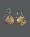There's nothing wrong with being a little unconventional. These artsy earrings by Jody Coyote feature a unique, textured brass drop and sterling silver wire swirl charm. Sterling silver french wire and accent bead. Approximate drop: 1-1/4 inches.