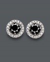 Sparkling studs add a bright and versatile touch to any look. Crafted in 14k white gold, earrings feature a round-cut black diamond center (7/8 ct. t.w.) encircled by sparkling, round-cut white diamonds (1/6 ct. t.w.). Approximate diameter: 1/3 inch.