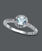 Subtle, simple, and sublime. This elegant Victoria Townsend style features a round-cut blue topaz gemstone (1/2 ct. t.w.) encircled by sparkling diamond accents. Crafted in sterling silver. Size 7.