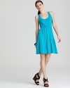 Eyelet cutouts atop this vivid Three Dots dress simply sing summer. Finish with pastel accents for pure feminine charm.