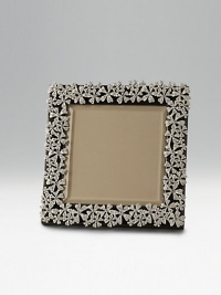 Polished and platinum-plated with ornate garland design. Leather back Arrives handsomely gift boxed Polished and platinum-plated with ornate garland design. Leather back Arrives handsomely gift boxed