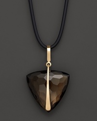Faceted, trillion cut smoky quartz, set in 14K yellow gold, hangs from a cord necklace. Faceted, trillion cut smoky quartz, set in 14K yellow gold, hangs from a cord necklace.