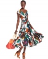 Covered in a bold pattern of tropical blossoms, a cap-sleeved Grace Elements dress peasant dress effortlessly embodies summer-ready style. Its swingy skirt creates soft movement while bright accessories make the look pop.