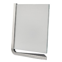 Movie vertical frames by Nambé. Designed by Neil Cohen for Nambé, these sleek metal frames feature a metal base and two squares of glass to protect your pictures. The movie frame is a wonderful gift for the home or office. Movie vertical frames by Nambé. Designed by Neil Cohen for Nambé, these sleek metal frames feature a metal base and two squares of glass to protect your pictures. The movie frame is a wonderful gift for the home or office.