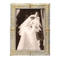 Sparkling starbright silver and lustrous dawn's gold highlight the textural patterns of this artfully handcrafted frame from Mariposa. Sparkling starbright silver and lustrous dawn's gold highlight the textural patterns of this artfully handcrafted frame from Mariposa.