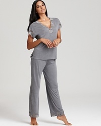 An elegant floral print short sleeve top and pants set with contrast lace trim from Natori. An elegant floral print short sleeve top and pants set with contrast lace trim from Natori.