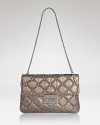 Quilted leather leaves an impression on this MICHAEL Michael Kors clutch, detailed with a classic turnlock closure. Its optional strap slides over the shoulder for hands free styling.