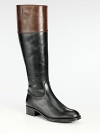 A tall silhouette of two-tone paneled leather will never go out of style. Rubber heel, 1¼ (30mm)Shaft, 15½Leg circumference, 14¼Leather upperSide zipLeather liningRubber solePadded insoleMade in Italy A tall silhouette of two-tone paneled leather will never go out of style. Rubber heel, 1¼ (30mm)Shaft, 15½Leg circumference, 14¼Leather upperSide zipLeather liningRubber solePadded insoleMade in Italy