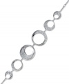 A modern and sophisticated interpretation of a timeless motif - the circle. Embellished with a touch of sparkling clear crystal pavé, Swarovski's fluid design complements a wide variety of outfits, making it very easy to wear. Crafted in rhodium-plated mixed metal. Approximate length: 6-1/2 inches.