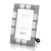A unique metal frame with precious mother of pearl features a fully studded four corner embellishment with hundreds of handset Swarovski crystals. The back of the frame uses a combination of metal and enamel with large Swarovski studs.